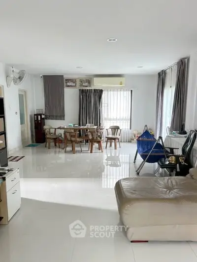 Spacious living room with modern furniture and large windows for natural light.