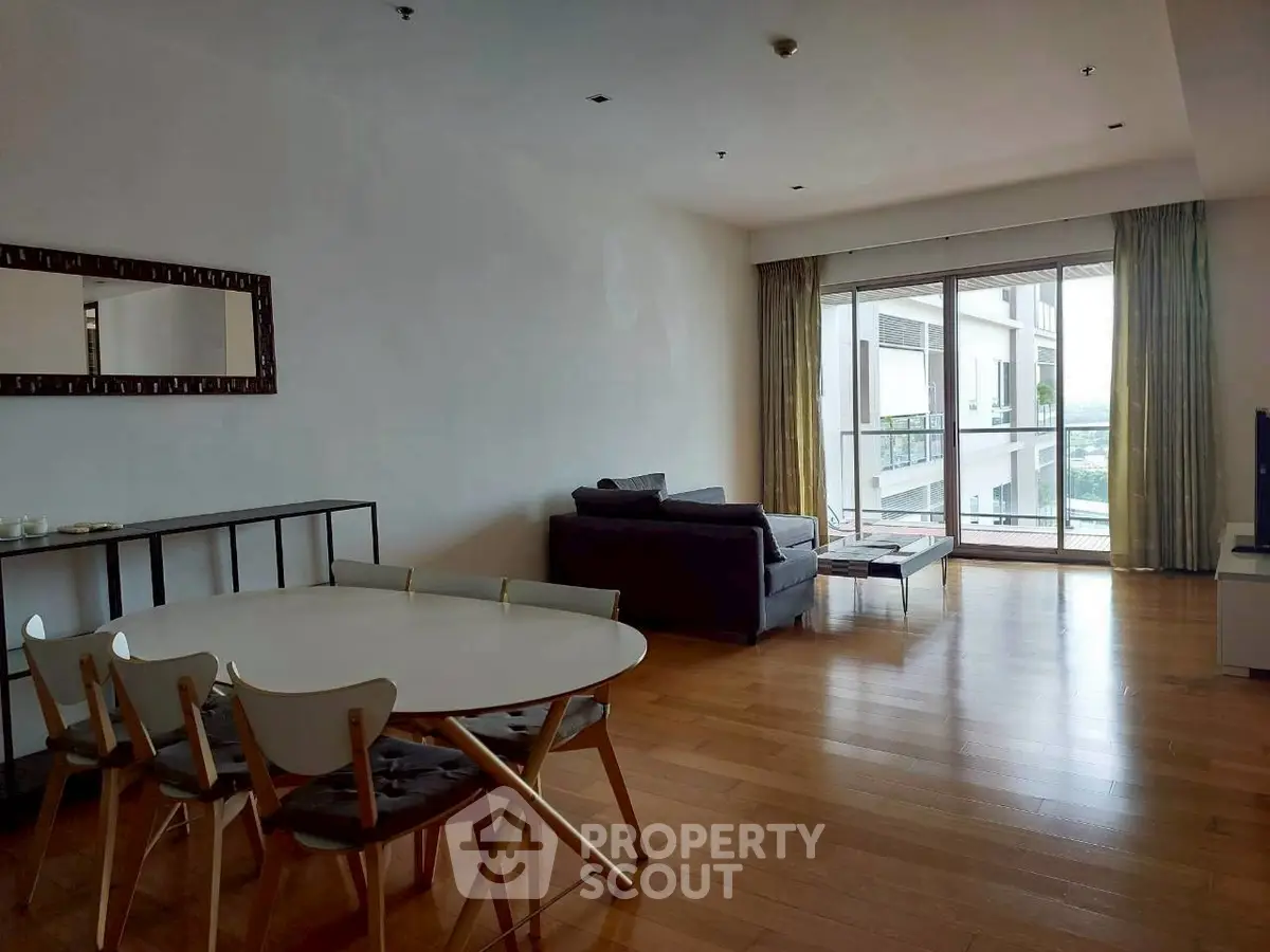 Spacious living room with modern furniture and large window offering natural light.