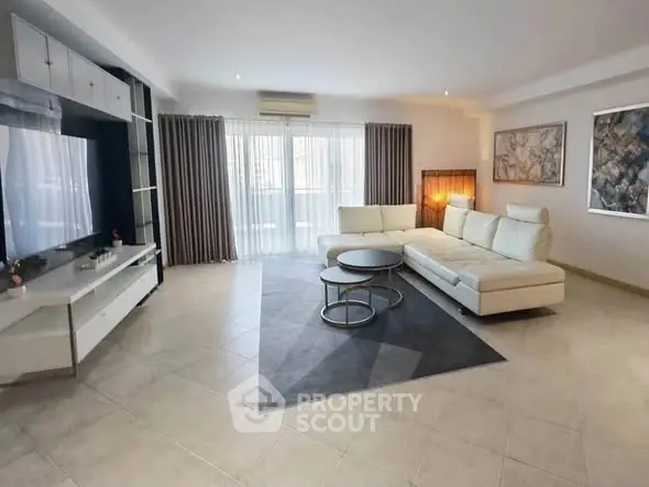 Spacious modern living room with elegant decor and large windows for natural light.
