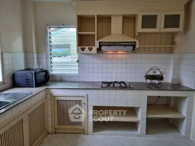 Charming kitchen with gas stove and ample storage space