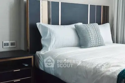 Luxurious bedroom with elegant headboard and plush bedding, perfect for relaxation and comfort.