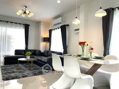 Modern living room with stylish decor, featuring a cozy seating area and elegant dining space.