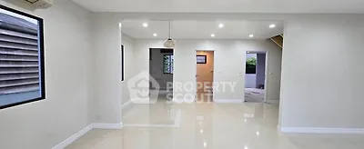 Spacious open-plan living area with modern lighting and glossy floors