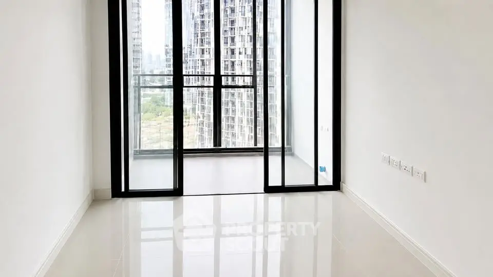 Spacious modern apartment with floor-to-ceiling windows and city view.