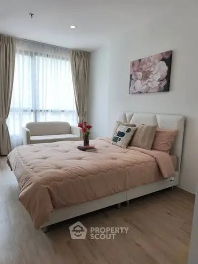 Elegant bedroom with cozy decor and natural light, featuring a stylish bed and modern furnishings.