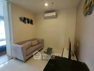 Cozy living room with modern decor and air conditioning in a stylish apartment.