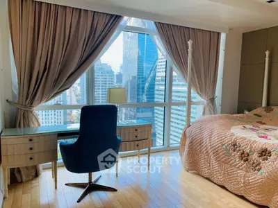 Luxurious bedroom with stunning city view, elegant furnishings, and natural light.