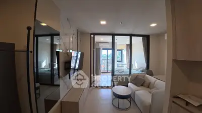 Modern living room with glass partition leading to a bedroom and balcony view.