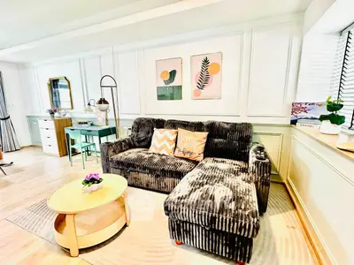 Chic living room with plush sofa, stylish decor, and natural light for a cozy ambiance.