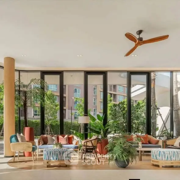Spacious and stylish living room with modern decor and large windows offering lush garden views.