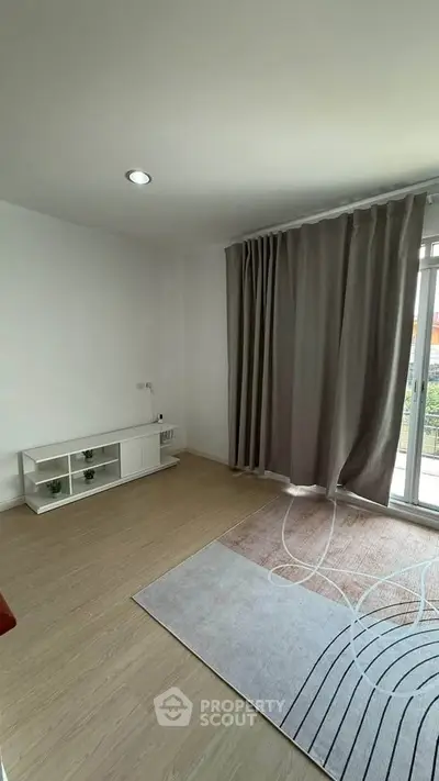 Bright and airy room with large window and modern decor