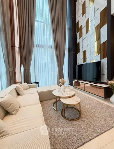 Luxurious high-ceiling living room with elegant decor and modern furniture