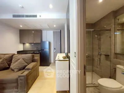 Modern apartment interior with cozy living room and sleek bathroom design.