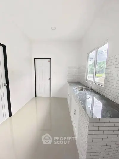 Modern kitchen with sleek countertops and ample natural light