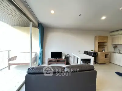 Spacious modern living room with balcony and open kitchen layout