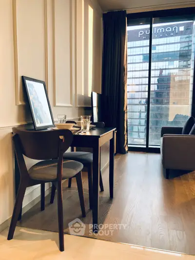 Modern living room with elegant furniture and city view through large window.