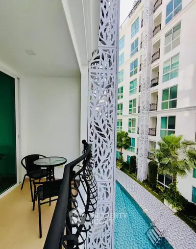 Chic balcony view overlooking modern pool and stylish building facade
