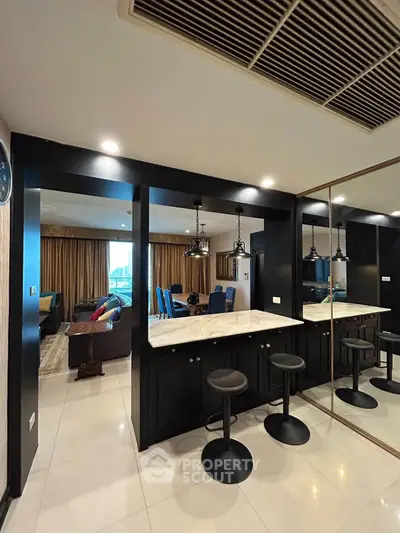 Modern open-plan living area with stylish bar seating and elegant decor