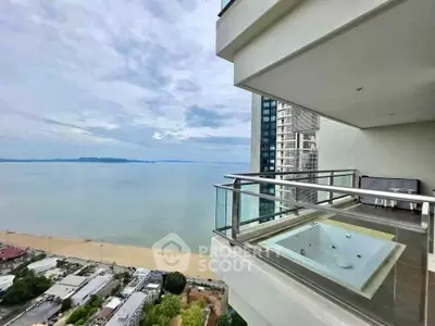 Stunning beachfront balcony with jacuzzi and panoramic ocean view.