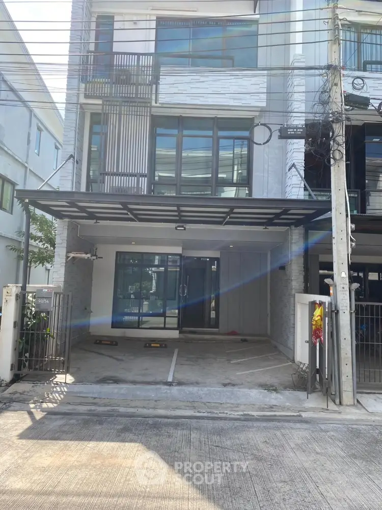 Modern townhouse exterior with spacious driveway and sleek design