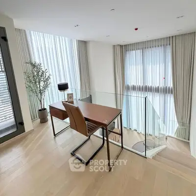 Elegant study area with modern desk and chair, featuring floor-to-ceiling windows and stylish decor.