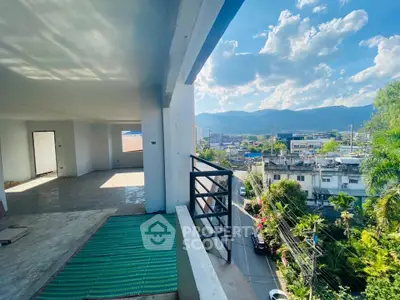 Spacious balcony with stunning city and mountain views, perfect for relaxation and entertaining.