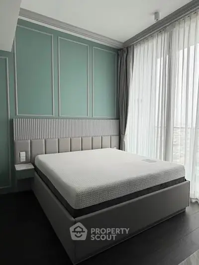 Luxurious bedroom with elegant design and large windows offering natural light.