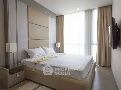 Luxurious bedroom with modern decor and large windows for natural light.