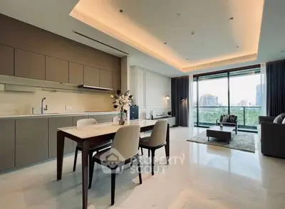 Luxurious open-plan living room with modern kitchen and stunning city view.