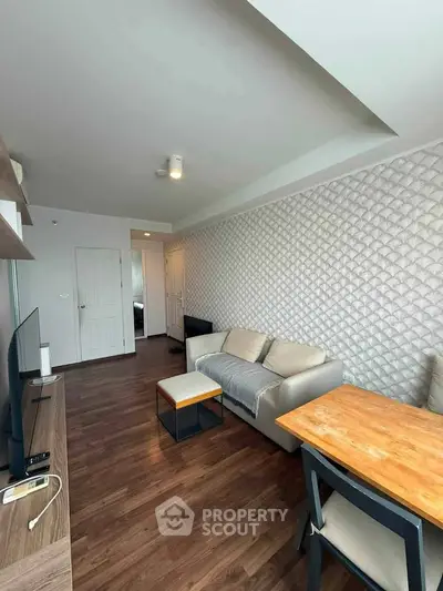 Modern living room with stylish decor and wooden flooring in a cozy apartment.