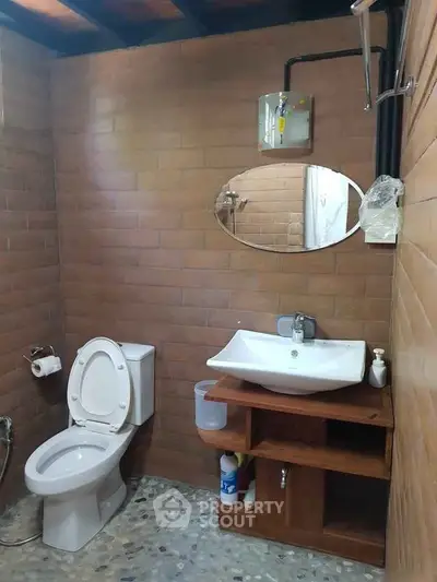 Charming rustic bathroom with modern fixtures and cozy wooden accents.