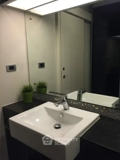 Modern bathroom with sleek sink and stylish mirror design