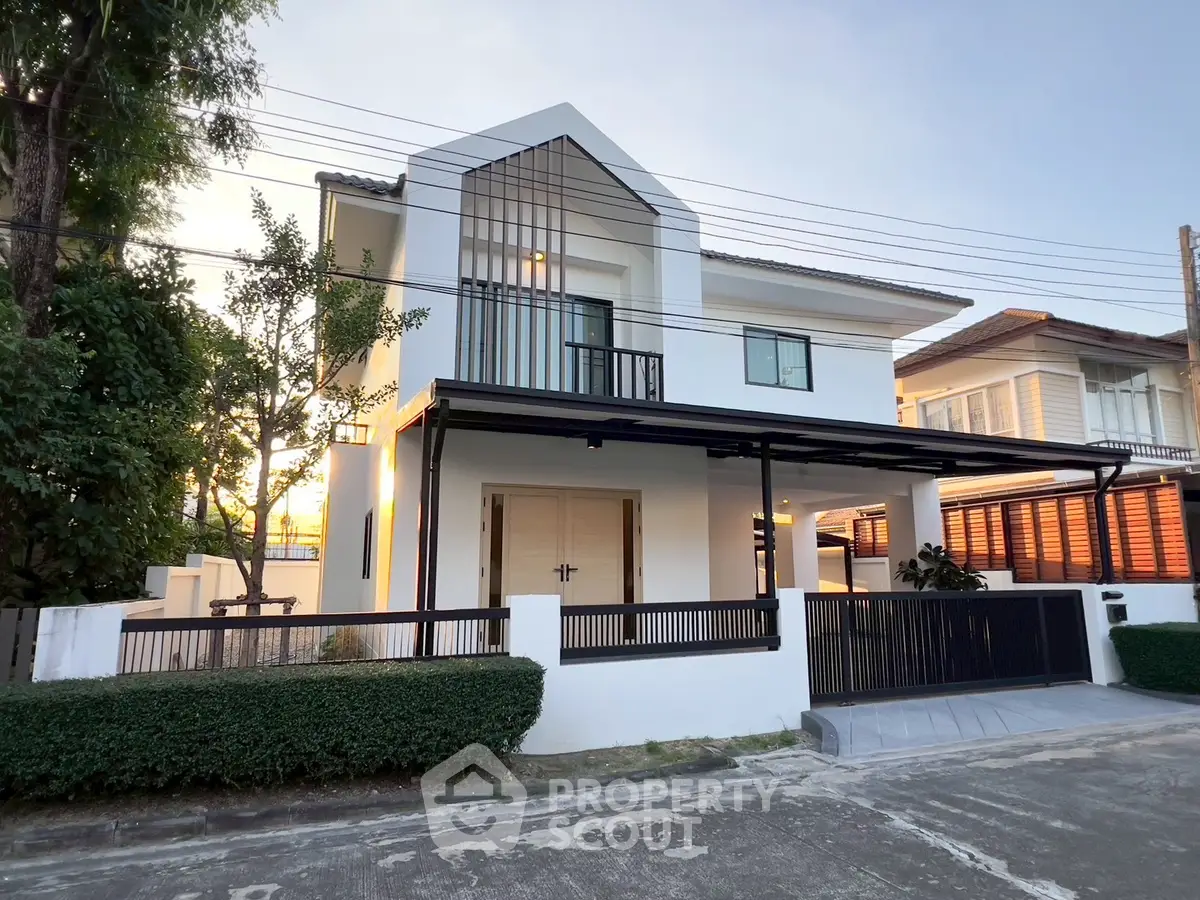 Modern two-story house with sleek design and spacious balcony in a serene neighborhood.