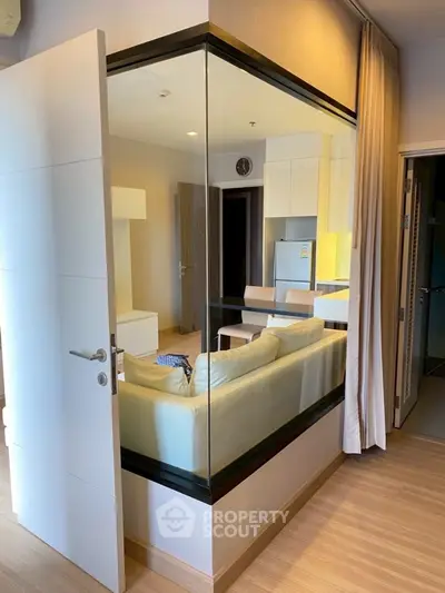 Modern living room with glass partition and cozy seating area