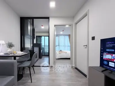 Modern apartment interior with open living and dining area, sleek kitchen, and cozy bedroom.