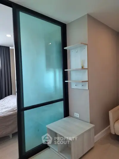 Modern bedroom with sliding glass door and minimalist shelving