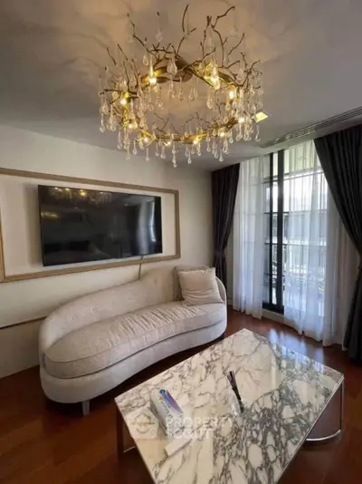 Elegant living room with designer chandelier and marble coffee table