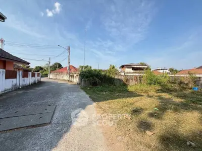 Charming suburban neighborhood with spacious plots and clear blue skies, ideal for new home construction.