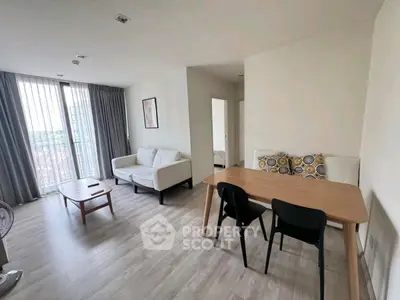 Modern living room with stylish furniture and large windows offering natural light.