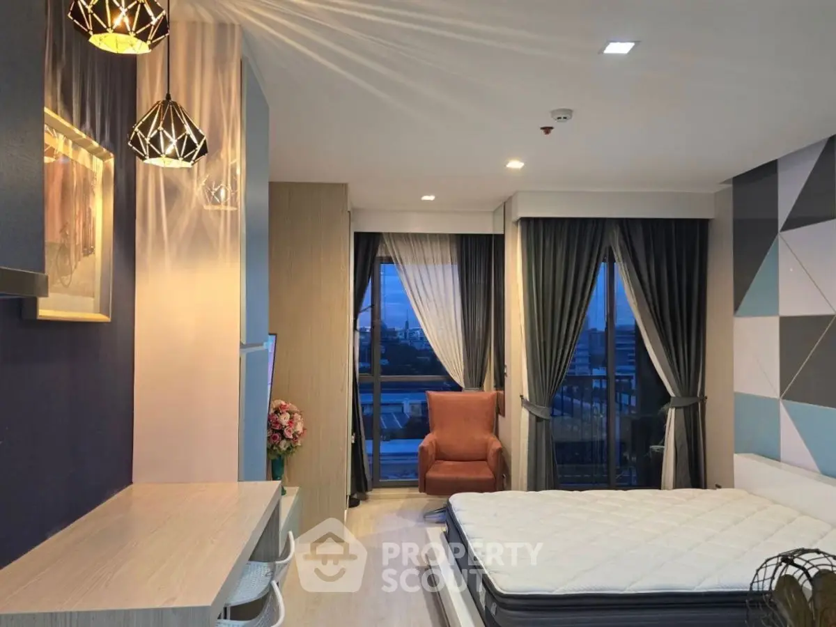 Modern bedroom with stylish decor and city view from balcony