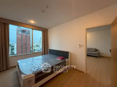 Spacious bedroom with city view in modern apartment