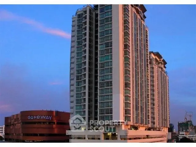 Stunning high-rise building exterior at sunset with modern architecture and city views.