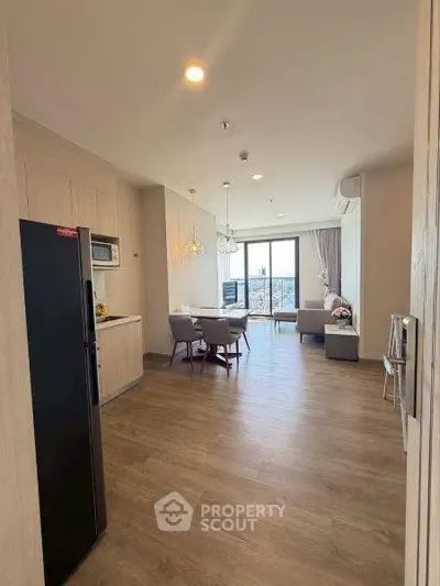 Modern open-plan living room with dining area and large window view