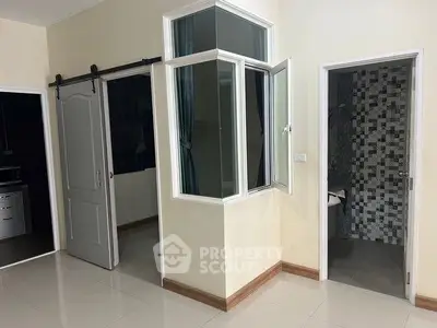 Modern interior with sliding door and tiled bathroom entrance