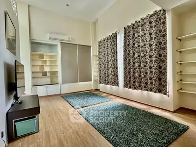 Spacious living room with modern decor and ample natural light