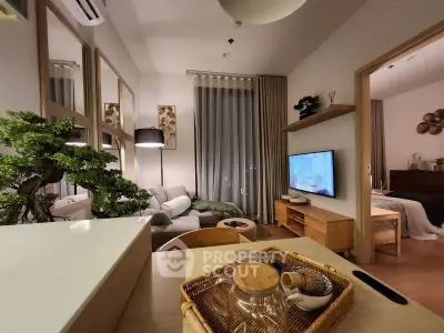 Modern living room with cozy decor and stylish furniture, featuring a wall-mounted TV and elegant lighting.
