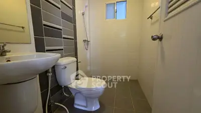 Modern bathroom with sleek tiles and compact design