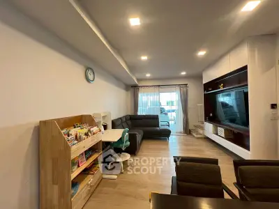 Spacious living room with modern furniture and entertainment center, perfect for family gatherings.