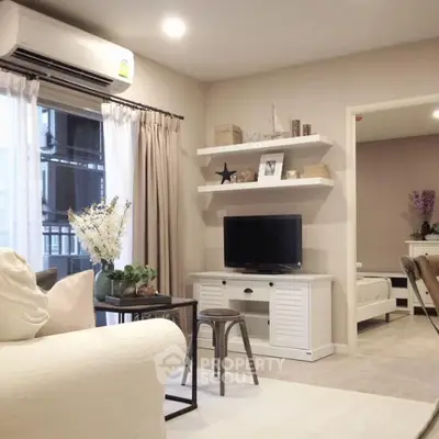 Modern living room with stylish decor and open view to bedroom