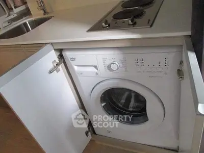 Compact kitchen with integrated washing machine and electric stove